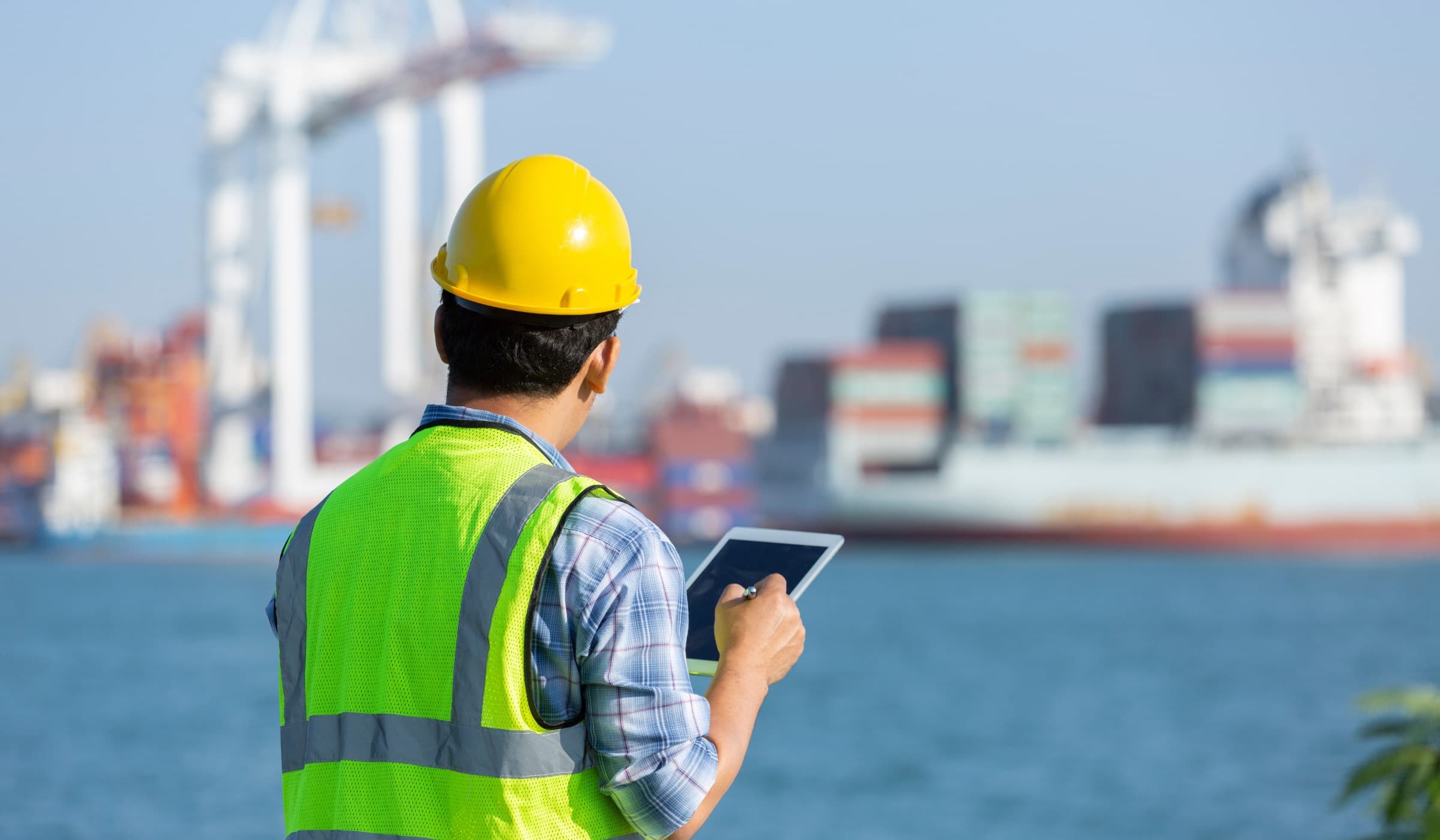 Cargo inspector reviewing container port activity for customs clearance