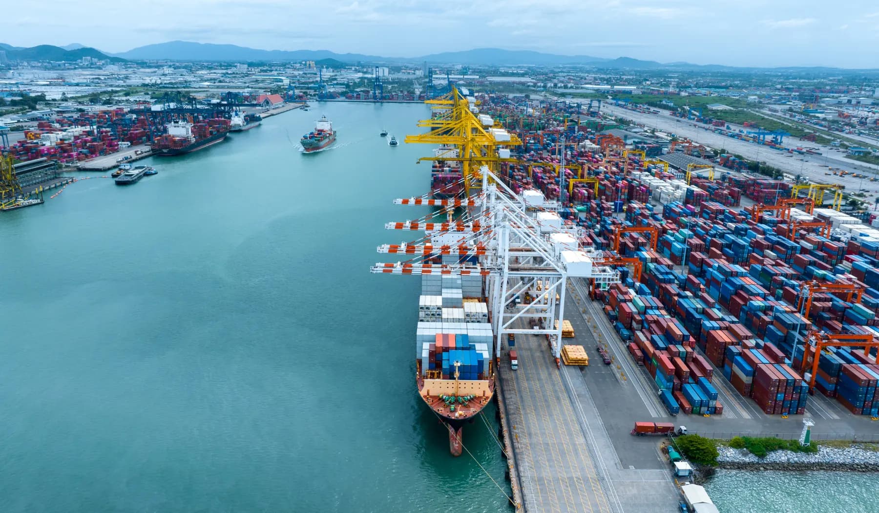 Container port with cargo ships, cranes, and import-export logistics activity