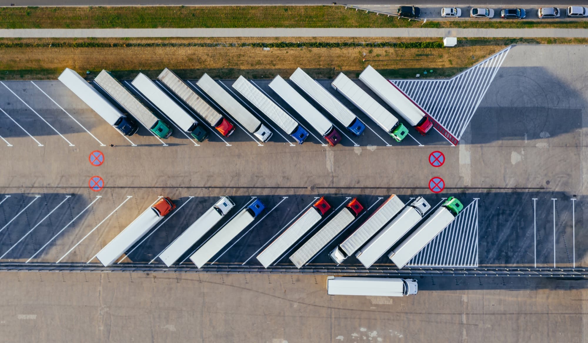 Aerial view of freight trucks lined up in a logistics terminal for route and 3PL opportunity planning