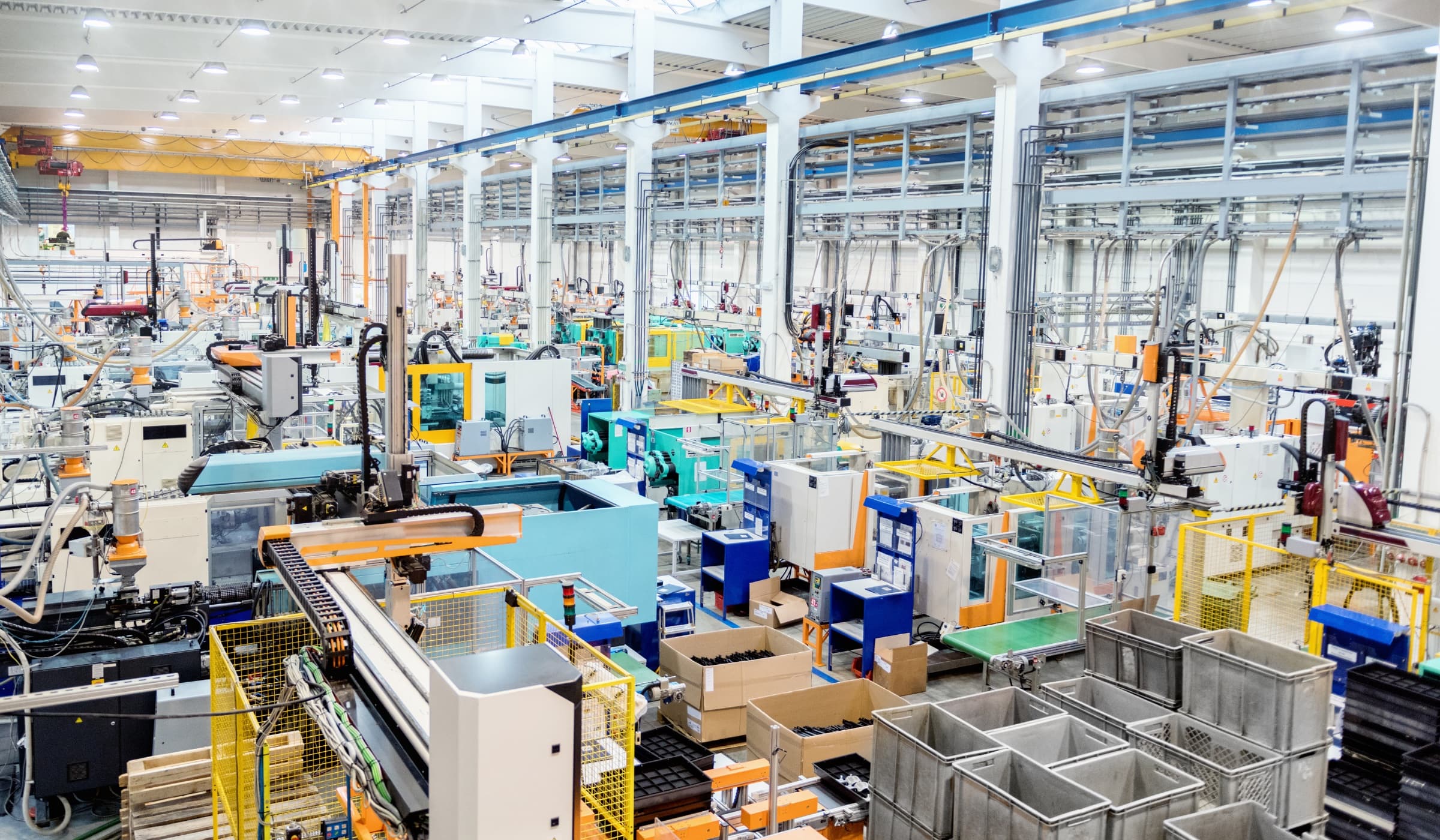Wide interior of an automated manufacturing production floor with industrial machinery