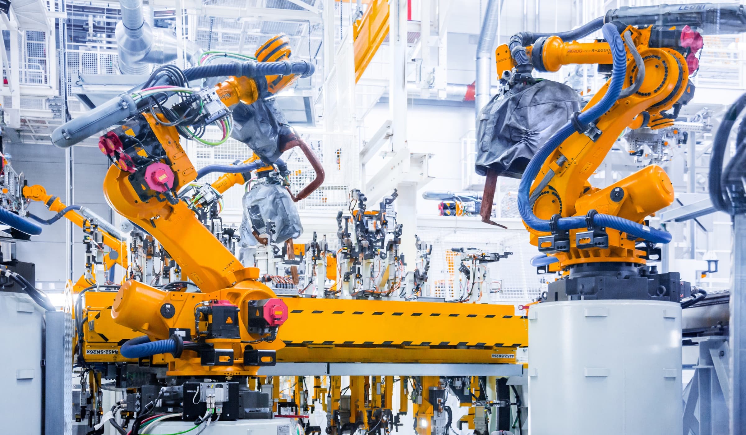 Automated smart factory production line with industrial robotic arms