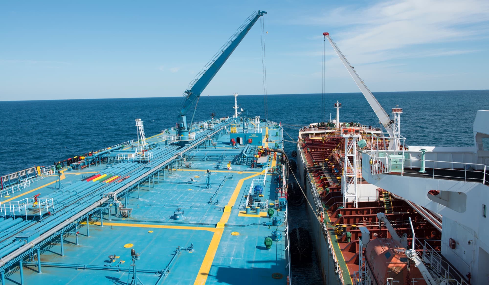 Cargo vessels operating side by side with deck cranes for shipping-line and NVOCC capacity planning